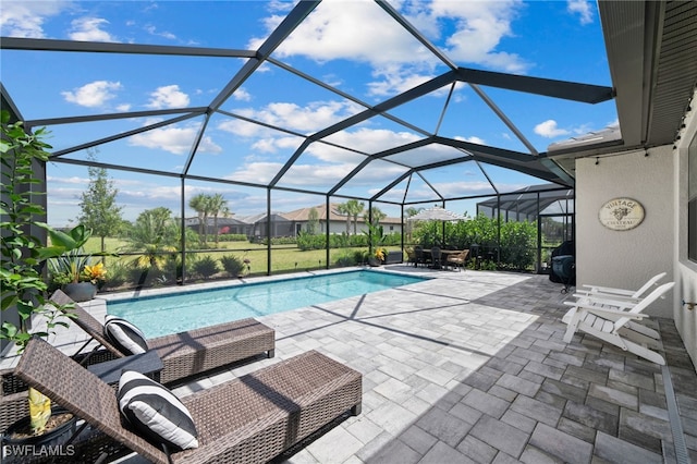 view of swimming pool with a patio and glass enclosure