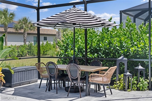 view of patio with glass enclosure