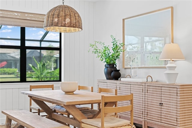 dining room with wood walls