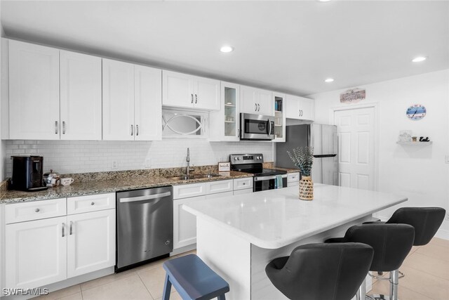 kitchen featuring white cabinetry, sink, and stainless steel appliances