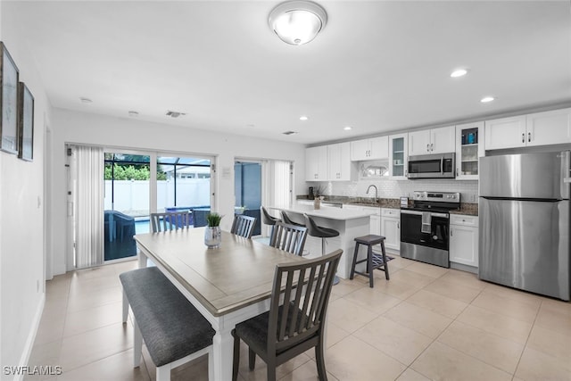 dining room with light tile patterned flooring and sink