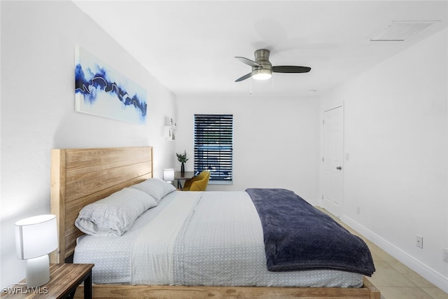 tiled bedroom featuring ceiling fan