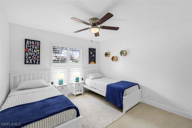 tiled bedroom featuring ceiling fan