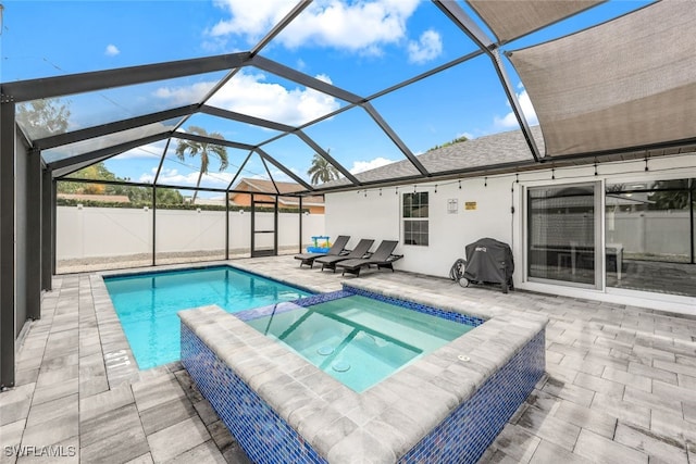 view of pool featuring an in ground hot tub, area for grilling, a lanai, and a patio area