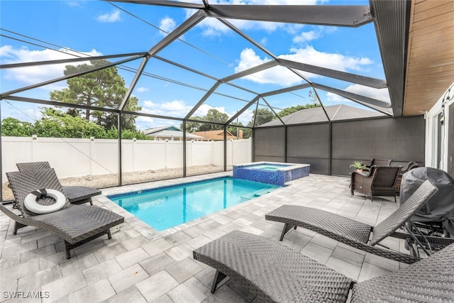 view of pool featuring an in ground hot tub, glass enclosure, grilling area, and a patio area