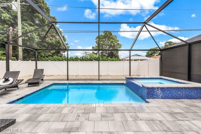 view of swimming pool featuring a lanai, an in ground hot tub, and a patio