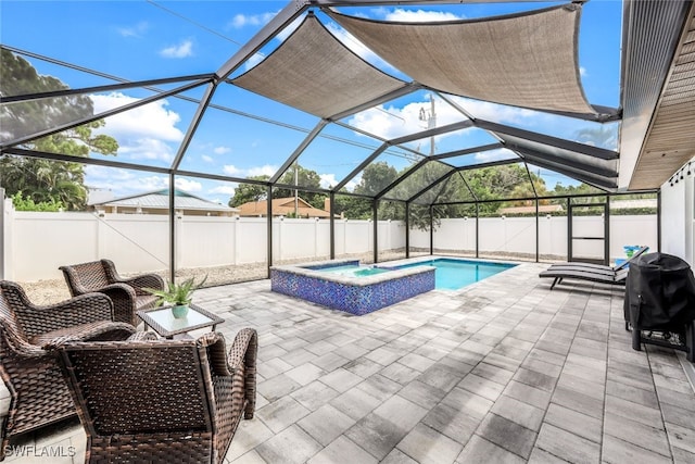 view of swimming pool with glass enclosure, area for grilling, a patio area, and an in ground hot tub