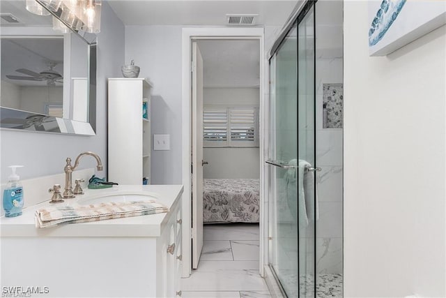 bathroom with ceiling fan, vanity, and walk in shower