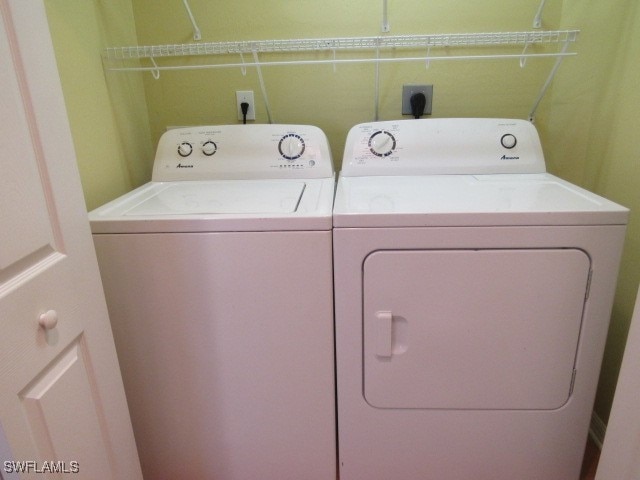 clothes washing area with separate washer and dryer