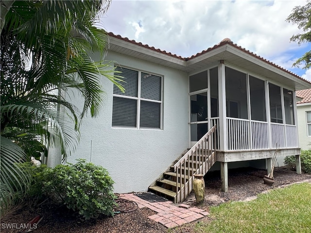 rear view of house with a sunroom