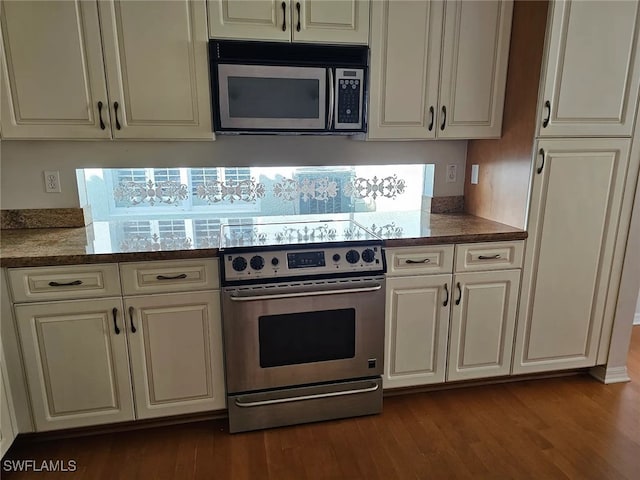 kitchen featuring light stone counters, stainless steel appliances, and dark hardwood / wood-style floors