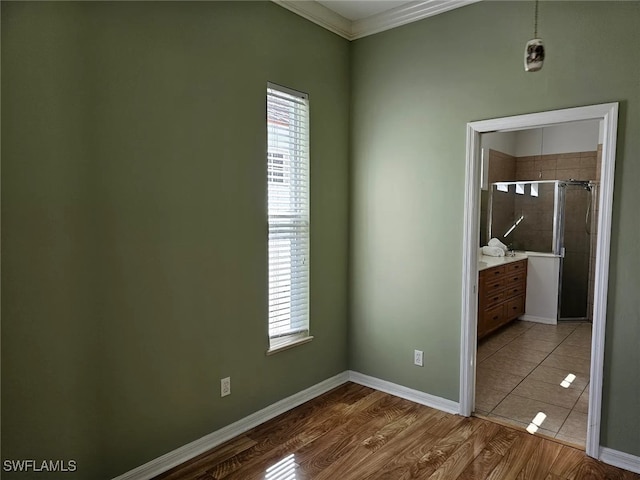 spare room featuring hardwood / wood-style flooring and ornamental molding