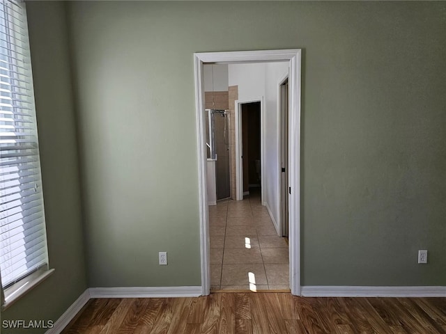 unfurnished room with wood-type flooring