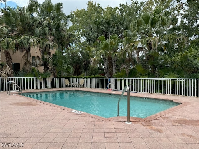 view of swimming pool with a patio area