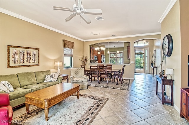 tiled living room with ceiling fan with notable chandelier, crown molding, and a healthy amount of sunlight