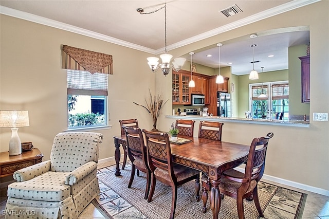 dining room with ornamental molding, a chandelier, and light tile patterned floors