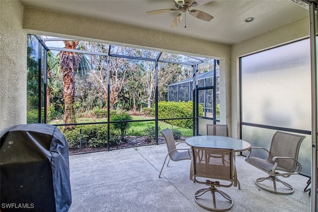 sunroom / solarium featuring ceiling fan