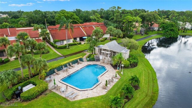 view of swimming pool featuring a patio, a lawn, and a water view