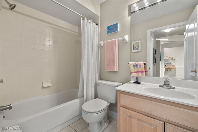 full bathroom featuring tile patterned floors, shower / bath combo with shower curtain, vanity, and toilet