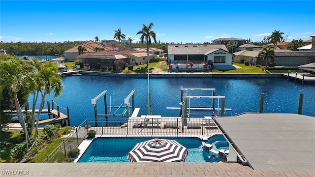 view of pool with a patio area, a dock, and a water view