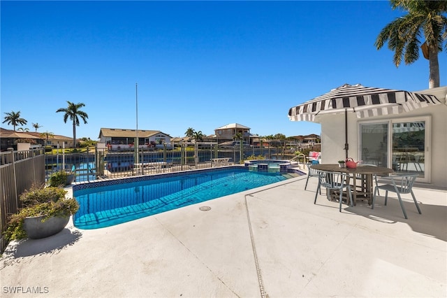 view of swimming pool with a patio area and a water view