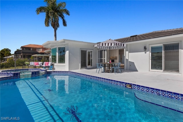 view of pool featuring a patio area and an in ground hot tub