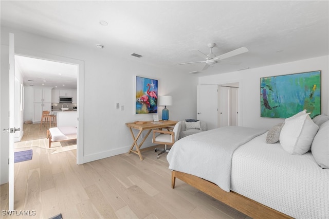 bedroom with light hardwood / wood-style floors and ceiling fan