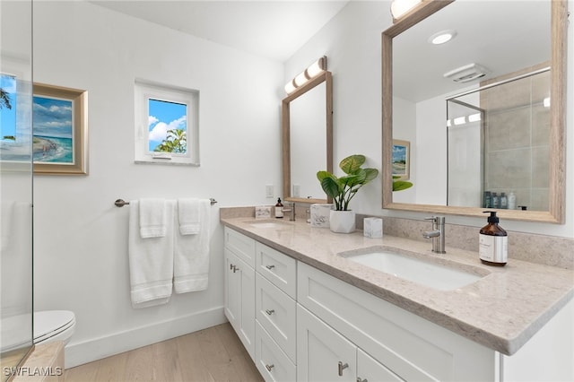 bathroom featuring toilet, hardwood / wood-style floors, and vanity