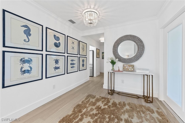 hallway featuring ornamental molding, a chandelier, and wood-type flooring