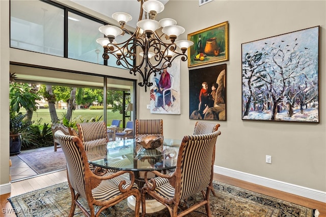 dining area featuring hardwood / wood-style flooring and a chandelier