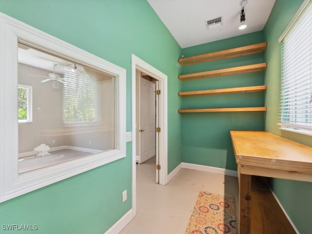 office area featuring baseboards, visible vents, a ceiling fan, concrete floors, and track lighting