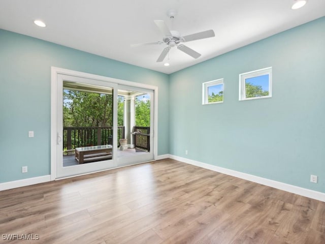 empty room with light wood-style floors, baseboards, a ceiling fan, and recessed lighting