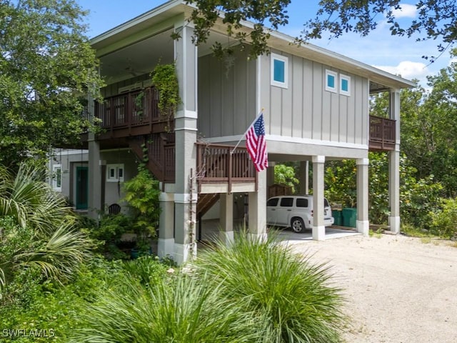 exterior space with a carport, board and batten siding, and driveway