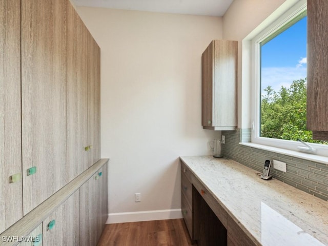 office with dark wood-style floors and baseboards