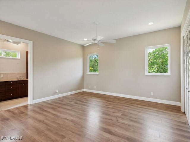 unfurnished bedroom featuring light wood finished floors and multiple windows