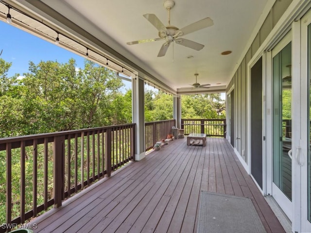 wooden terrace featuring a ceiling fan