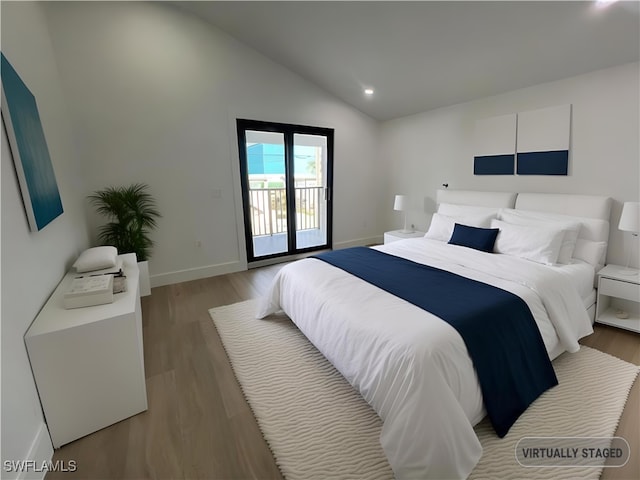 bedroom featuring access to exterior, light hardwood / wood-style floors, and vaulted ceiling