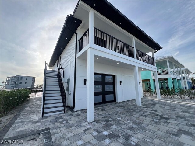 rear view of property featuring a garage