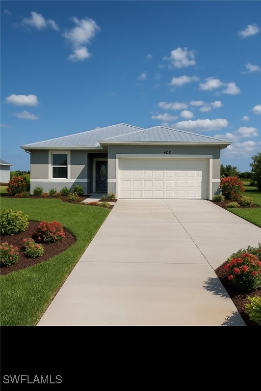 603 Marcella Ter, Labelle, FL 33935 - view of front of house with concrete driveway, stucco siding, an attached garage, and a front lawn