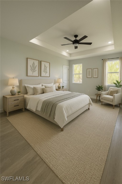 603 Marcella Ter, Labelle, FL 33935 - bedroom featuring multiple windows, baseboards, wood finished floors, and a raised ceiling