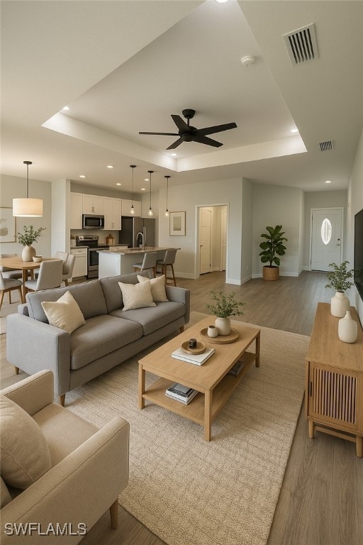 603 Marcella Ter, Labelle, FL 33935 - living room with baseboards, a raised ceiling, ceiling fan, and visible vents
