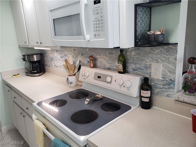 kitchen featuring white cabinets, decorative backsplash, and white appliances