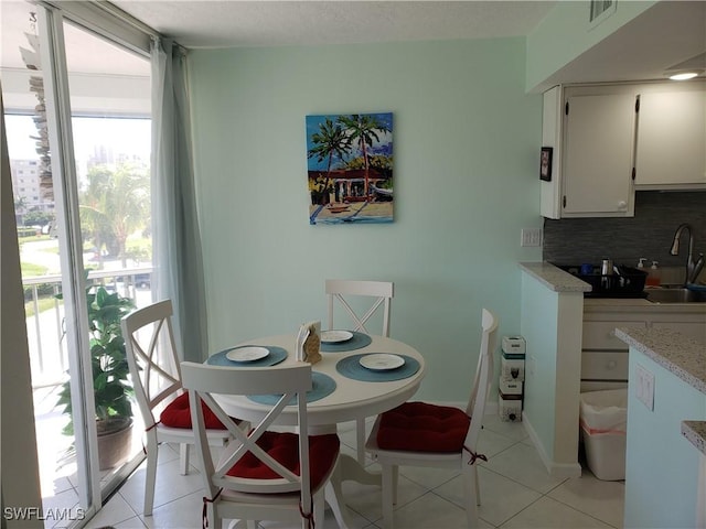 tiled dining room with sink