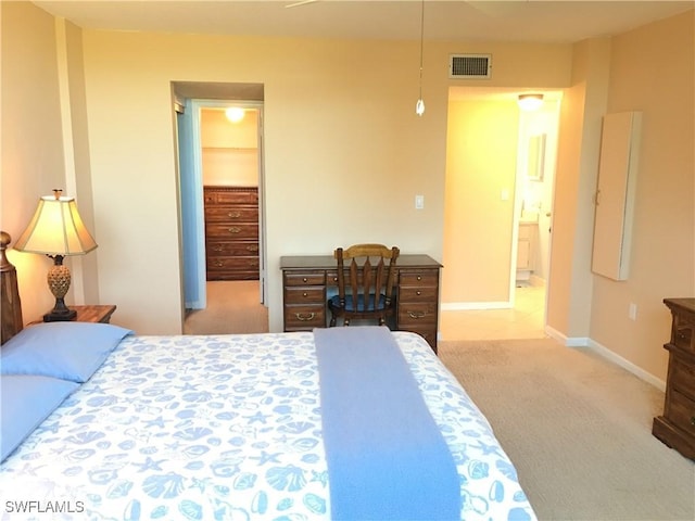 carpeted bedroom featuring ensuite bath