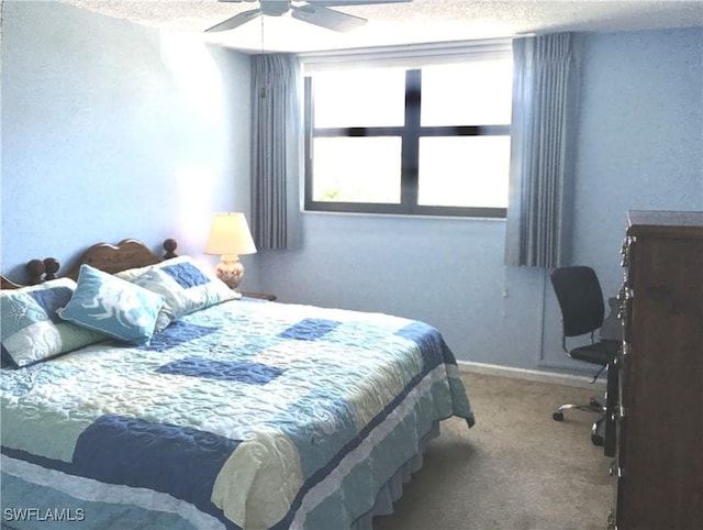 carpeted bedroom with ceiling fan and a textured ceiling