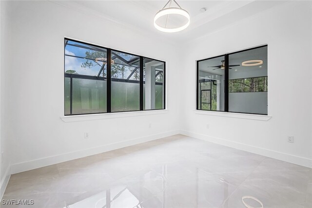 spare room with ceiling fan and tile patterned flooring