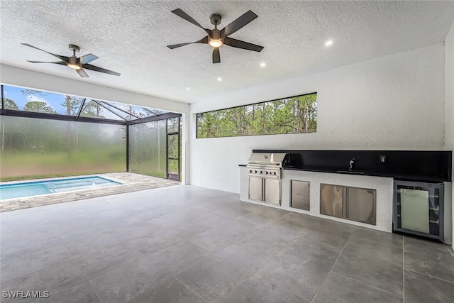 interior space featuring ceiling fan, sink, and a grill