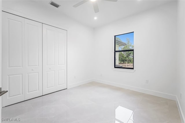 unfurnished bedroom featuring light tile patterned floors, ceiling fan, and a closet