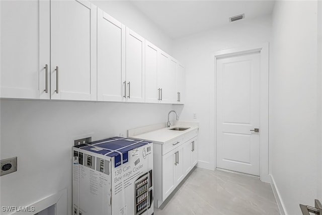 laundry room with light tile patterned flooring, sink, cabinets, hookup for an electric dryer, and hookup for a washing machine