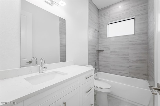 full bathroom featuring toilet, tiled shower / bath, and vanity